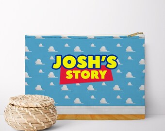 May include: A blue zippered pouch with a white cloud pattern. The pouch has the text "JOSH'S STORY" in yellow and red letters.