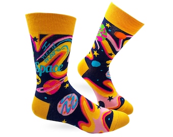 May include: A pair of yellow and blue socks with a space-themed design. The socks feature planets, stars, and the text "I need my space".