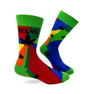 May include: A pair of colorful socks with a green, red, blue, and orange geometric pattern. The socks feature a black marijuana leaf design and the word "RELAX" in black text.