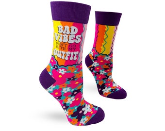 May include: A pair of colorful socks with a floral pattern and the text "Bad Vibes Don't Go With My Outfit".