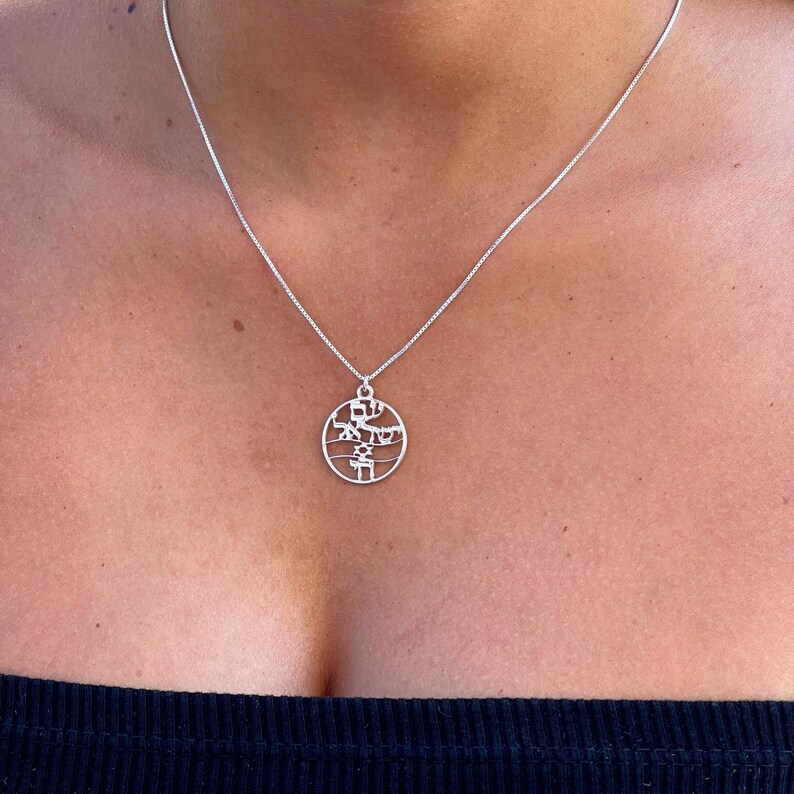 May include: A silver chain necklace with a round pendant featuring Hebrew lettering.