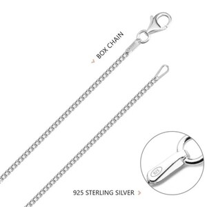 May include: A silver box chain necklace with a lobster clasp and a 925 sterling silver stamp. The chain is made of small, square links.