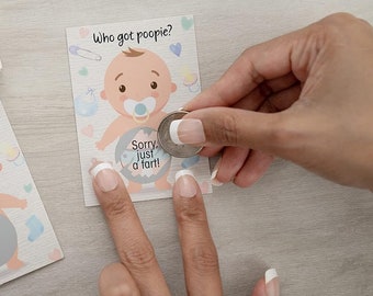 May include: A baby shower game card with a cartoon baby wearing a diaper and a pacifier. The card says "Who got poopie?" and "Sorry, just a fart!"