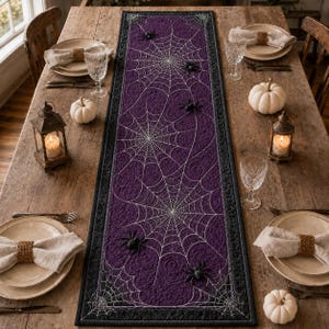 May include: A rectangular table runner featuring a deep purple fabric base with white stitched spider web patterns and black spider appliques. The runner has a dark black border and is centered on a wooden table with place settings.