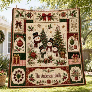 May include: A quilted throw blanket featuring a central scene of four snowmen in top hats and scarves surrounded by Christmas trees, gifts, and holly. The border includes ornaments, bows, and the text The Anderson Family in a decorative frame.