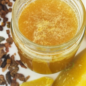 May include: A glass jar filled with thick, golden honey. The honey has a slightly cloudy appearance, indicating its natural, unfiltered quality.