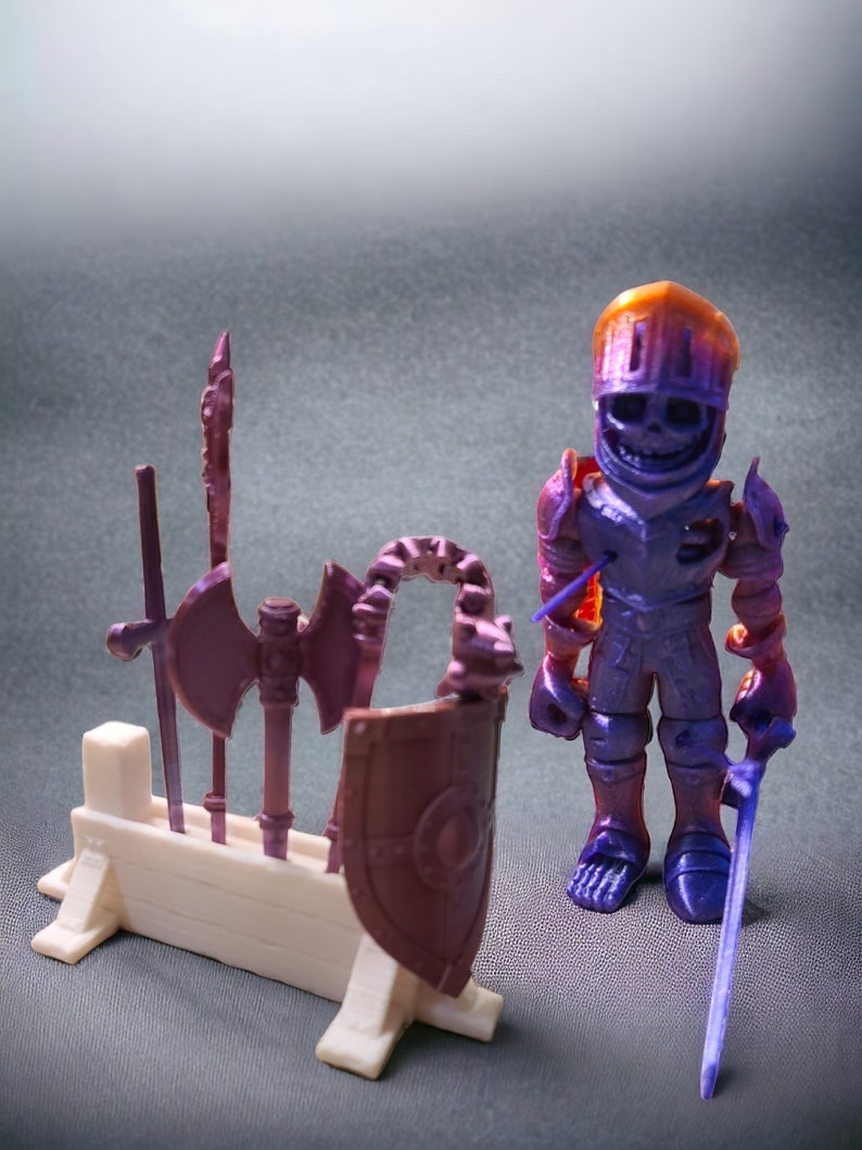 May include: A purple and orange 3D printed skeleton knight figurine holding a purple sword. The knight is standing next to a white wooden stand with a purple shield and various weapons.