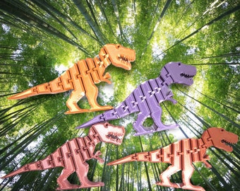 May include: Four articulated dinosaur toys made of plastic. The dinosaurs are orange, purple, brown, and green. They are posed in a playful manner against a backdrop of bamboo.