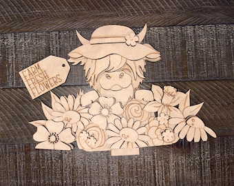 May include: Wooden craft kit featuring a Highland cow wearing a hat and holding a bouquet of flowers. The kit includes a sign that says "Farm Fresh Flowers".