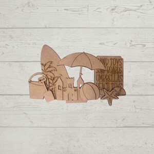 May include: Wooden cutouts of beach-themed items, including a surfboard, beach umbrella, sandcastle, pail, shovel, beach ball, starfish, and a sign that reads "Sand Toys, Surf Boards, Umbrellas, Beach Toys".