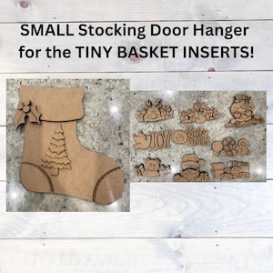 May include: A wooden stocking door hanger with a Christmas tree design and a holly sprig. The hanger is accompanied by a set of small wooden Christmas ornaments, including a reindeer, a snowman, a Santa Claus, and a gingerbread house.
