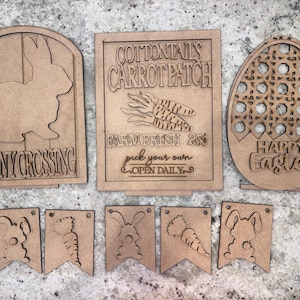 May include: Wooden signs with bunny and carrot designs. The signs read "Bunny Crossing" and "Cottontail's Carrot Patch Farm Fresh 25¢ Pick Your Own Open Daily". There is also a wooden egg-shaped sign that reads "Happy Easter".