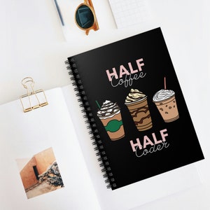 May include: Black spiral notebook with the text "Half Coffee Half Coder" in pink lettering. Three iced coffee drinks are illustrated on the cover.