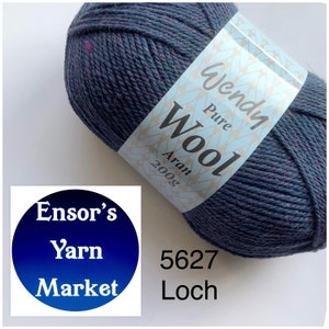 May include: A ball of Wendy Pure Wool Aran yarn in the colour Loch, shade 5627. The yarn is a dark blue with flecks of purple and green. The label reads "Wendy Pure Wool Aran 200g".