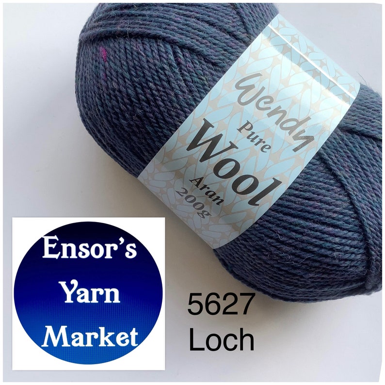 May include: A ball of Wendy Pure Wool Aran yarn in the colour Loch, shade 5627. The yarn is a dark blue with flecks of purple and green. The label reads "Wendy Pure Wool Aran 200g".