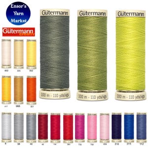 May include: A selection of Gütermann thread spools in a range of colours, including greens, yellows, oranges, reds, pinks, blues, and neutrals. Each spool is labelled with the brand name and thread length of 100 metres.