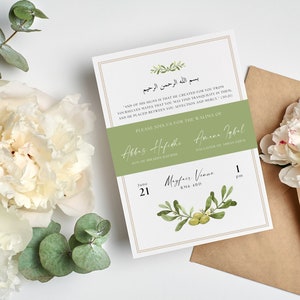 May include: Wedding invitation with olive branch and floral design. The invitation includes the names Abbas Hafidhe and Amana Iqbal, the date June 21, and the time 1 pm. The invitation is on a white background with a brown envelope.