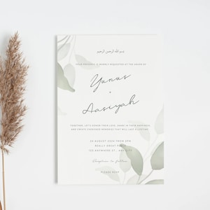 May include: Wedding invitation featuring calligraphy and watercolour eucalyptus leaves. The invitation includes the names Yunus and Aasiyah, event details, and a request for RSVP. The design is minimalist with a soft, neutral colour palette.