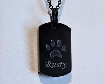 May include: Black dog tag necklace with a paw print and the name "Rusty" engraved on it.