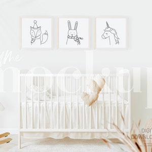 May include: Three framed black and white line drawings of animals in a nursery setting. The drawings are of a fox wearing a hat, a rabbit wearing a scarf, and a unicorn. The frames are white and have a natural wood finish. The drawings are hanging on a white wall above a white crib with a white mattress and a beige and white striped pillow. There is a rocking horse in the foreground.