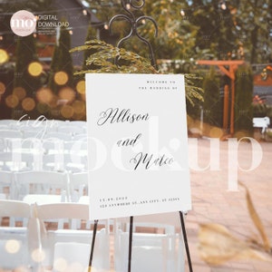 May include: White wedding sign with black calligraphy text that reads "Welcome to the wedding of Allison and Mateo" with the date "15.09.2023" and address "123 Anywhere St. Any City, ST 12345".