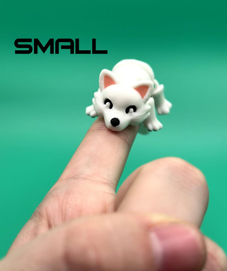 May include: White, small, plastic figurine of a dog with black eyes and pink ears. The dog is sitting on a finger.