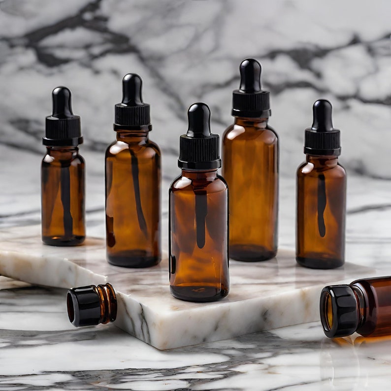 a marble table topped with brown bottles filled with essential oils