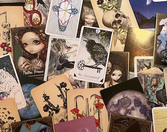 May include: A collection of tarot cards featuring illustrations of a variety of characters and symbols. The cards are arranged in a random order, with some cards overlapping others. The cards are all different colors and have a variety of designs.