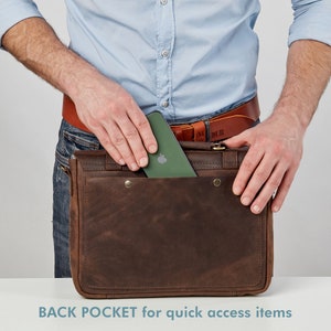 May include: A brown leather messenger bag with a back pocket for quick access items. A green phone is being placed in the pocket.