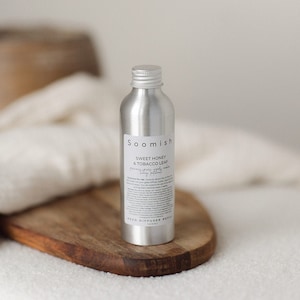 May include: A silver metal bottle with a black label that reads "Soomish Sweet Honey & Tobacco Leaf" and "Reed Diffuser Refill 140ml".