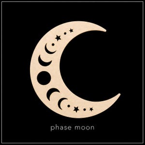 May include: A light beige crescent moon cutout featuring laser-cut details of various moon phases, small stars, and circular dots along its surface. The text "phase moon" is printed in white at the bottom centre of the crescent moon shape.