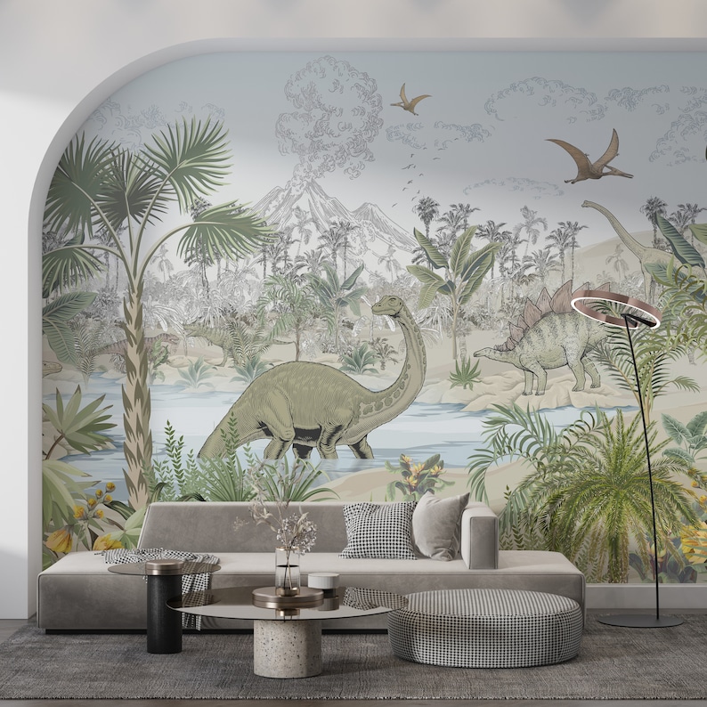 May include: A living room with a gray couch and a gray ottoman. The wall behind the couch has a mural of a prehistoric jungle scene with dinosaurs and palm trees.
