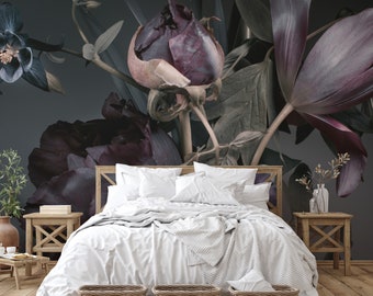 May include: A white bed with a white blanket and two white pillows sits in front of a dark gray wall with a large floral mural featuring dark purple and green flowers.