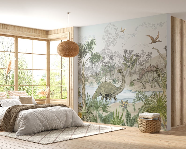 May include: A bedroom with a large wall mural featuring a jungle scene with dinosaurs, palm trees, and a volcano. The mural is in shades of green, brown, and blue. A bed with white bedding and a brown knitted throw blanket is in the foreground. A wicker pendant light hangs from the ceiling.