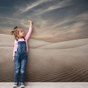 A beautiful sky meets the soft ridges of desert dunes in this nature-themed wallpaper mural.