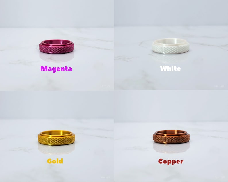 May include: Four different colored rings with a textured surface. The rings are magenta, white, gold, and copper.