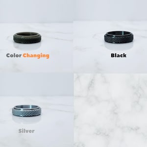 May include: Three silicone rings in different colors: color changing, black, and silver. The rings are textured and have a grooved design.