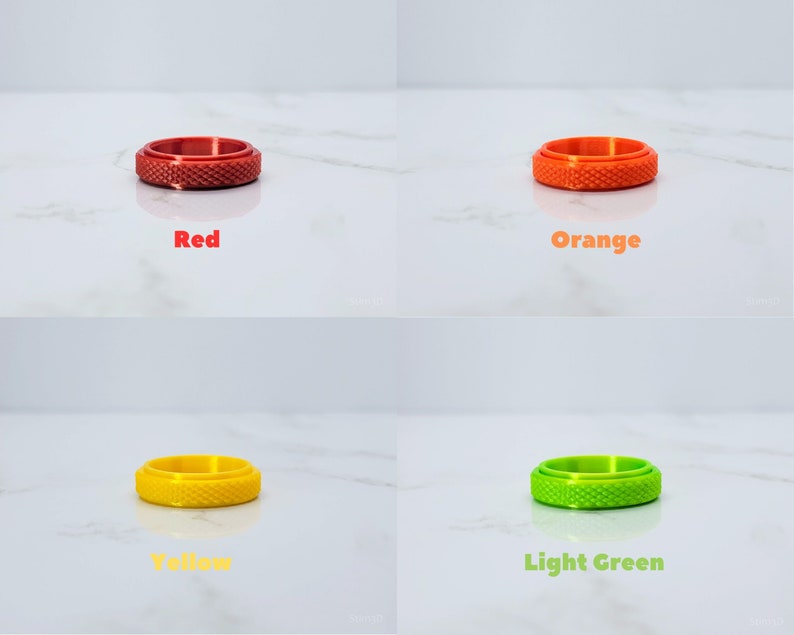 May include: Four different colored rings with a textured surface. The rings are red, orange, yellow, and light green.