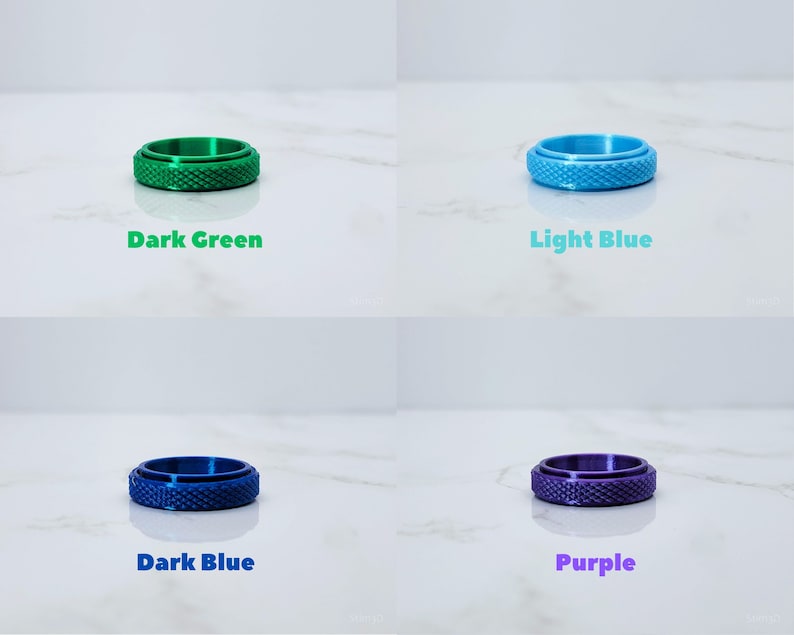May include: Four different colored rings with a textured surface. The rings are dark green, light blue, dark blue, and purple.