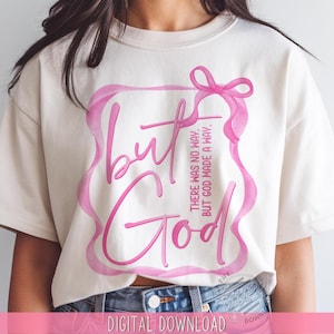 May include: A white t-shirt with a pink design that says "but God" with the text "There was no way, but God made a way." in pink lettering.