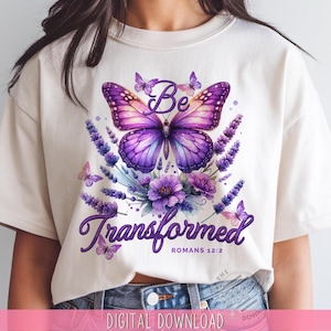 Può includere: Una maglietta bianca con una farfalla viola, fiori di lavanda e il testo "Be Transformed Romans 12:2".