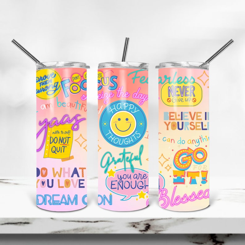 May include: Three pink and orange stainless steel tumblers with motivational phrases and designs. The tumblers have a gradient background with pink at the top and orange at the bottom. The phrases on the tumblers include 'Focus', 'Fearless Never Give Up', and 'Believe in Yourself'. The designs on the tumblers include a smiley face with the words 'Happy Thoughts', a star with the words 'You Are Enough', and a star with the words 'Go For It!'.