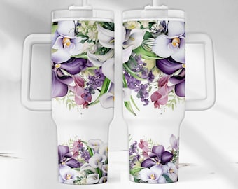 May include: Two white travel mugs with a floral design. The design features purple, white, and green flowers. The mugs have a handle and a straw.