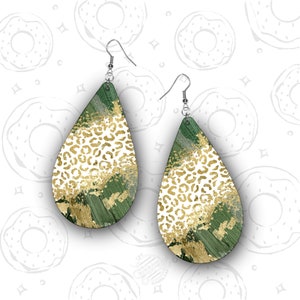 May include: A pair of green and gold teardrop-shaped earrings with a leopard print and gold glitter design.