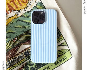 May include: A light blue iPhone case with vertical white stripes. The case is displayed on patterned fabric with text reading "WAHIAWA TOWN. HAWAII". The case is MagSafe compatible and made of high quality material.