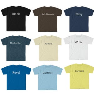 May include: Nine different color t-shirts with the color name printed on each shirt. The colors are black, dark chocolate, navy, heather navy, natural, white, royal, light blue, and cornsilk.