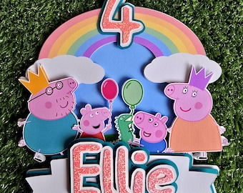 May include: A Peppa Pig themed cake topper with a rainbow, clouds, and the characters Peppa Pig, George Pig, Daddy Pig, and Mummy Pig. The topper also includes the number 4 and the name "Ellie".