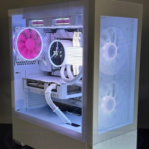 May include: A white computer case with a glass side panel, showcasing internal components. The case features a pink fan, a white liquid cooler with a digital display, and a graphics card. The text "LEGENDARY COMPUTERS" is visible at the bottom.