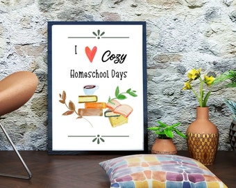 May include: A framed print with the text "I ♥ Cozy Homeschool Days" and a watercolor illustration of a stack of books, a cup of coffee, and leaves.