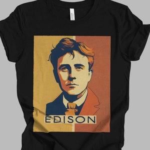 May include: Black t-shirt with a vintage-style illustration of Thomas Edison. The illustration is in shades of red, orange, yellow, and blue. The text "EDISON" is printed in white below the illustration.